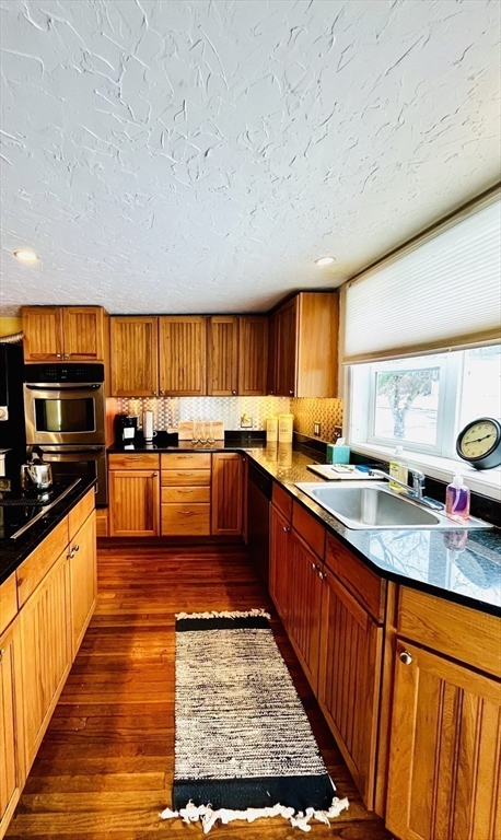 214-216 River Road East Berlin, MA 01503 - Photo 4 of 16 a kitchen with stainless steel appliances granite countertop wooden cabinets a sink and a stove