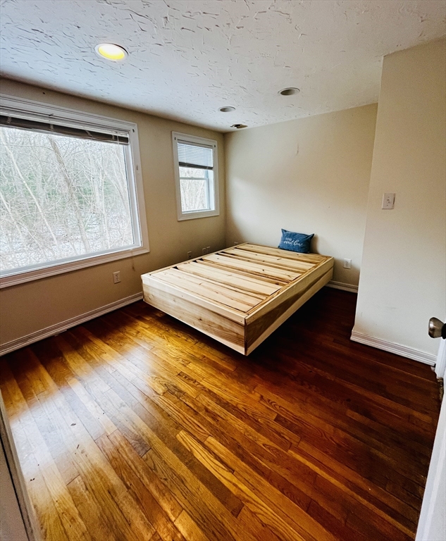 214-216 River Road East Berlin, MA 01503 - Photo 9 of 16 a bed sitting in a bedroom next to a window
