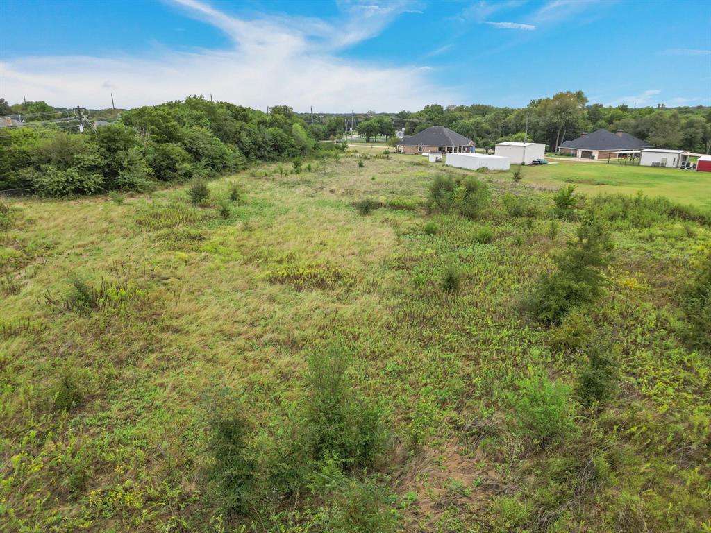 1061 Blackchamp Road Waxahachie, TX 75167 - Photo 16 of 22 a view of a green field with lots of trees in it