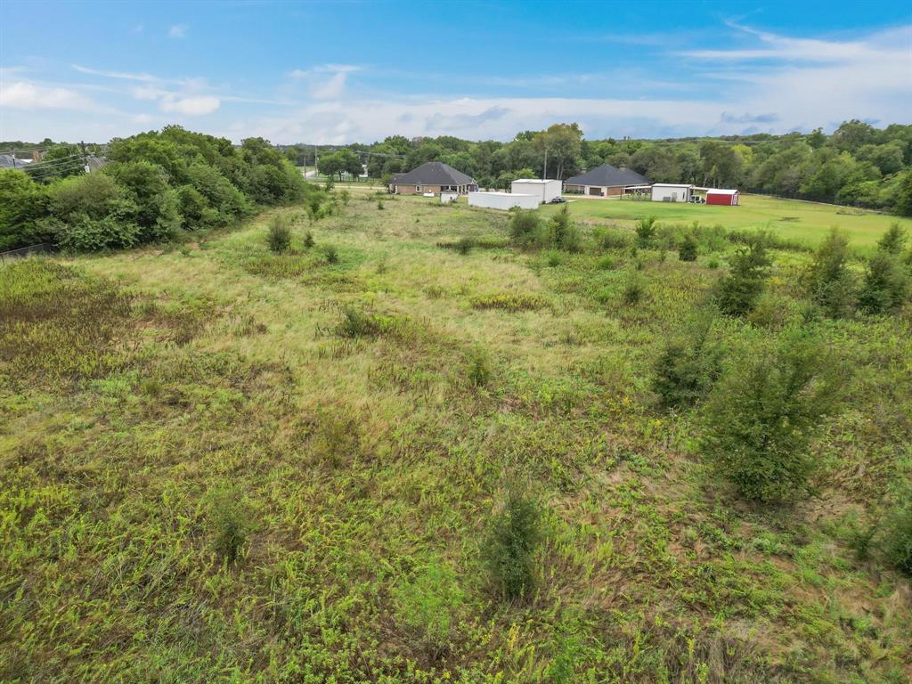 1061 Blackchamp Road Waxahachie, TX 75167 - Photo 17 of 22 a view of a green field with lots of bushes