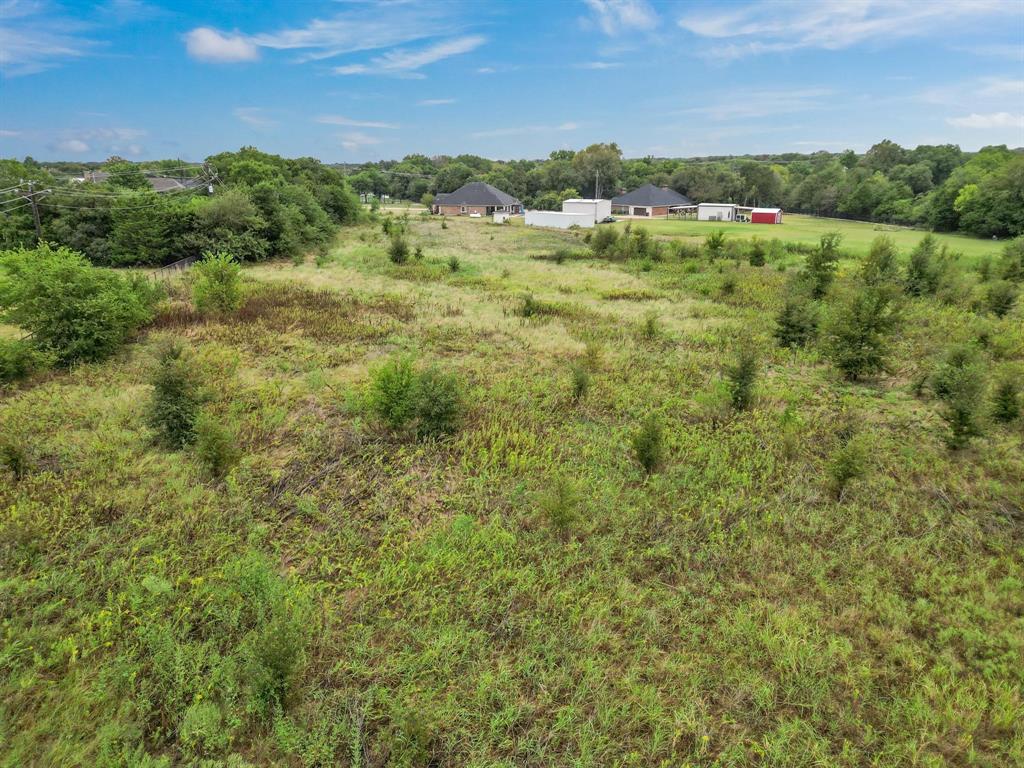 1061 Blackchamp Road Waxahachie, TX 75167 - Photo 18 of 22 a view of a green field with lots of bushes