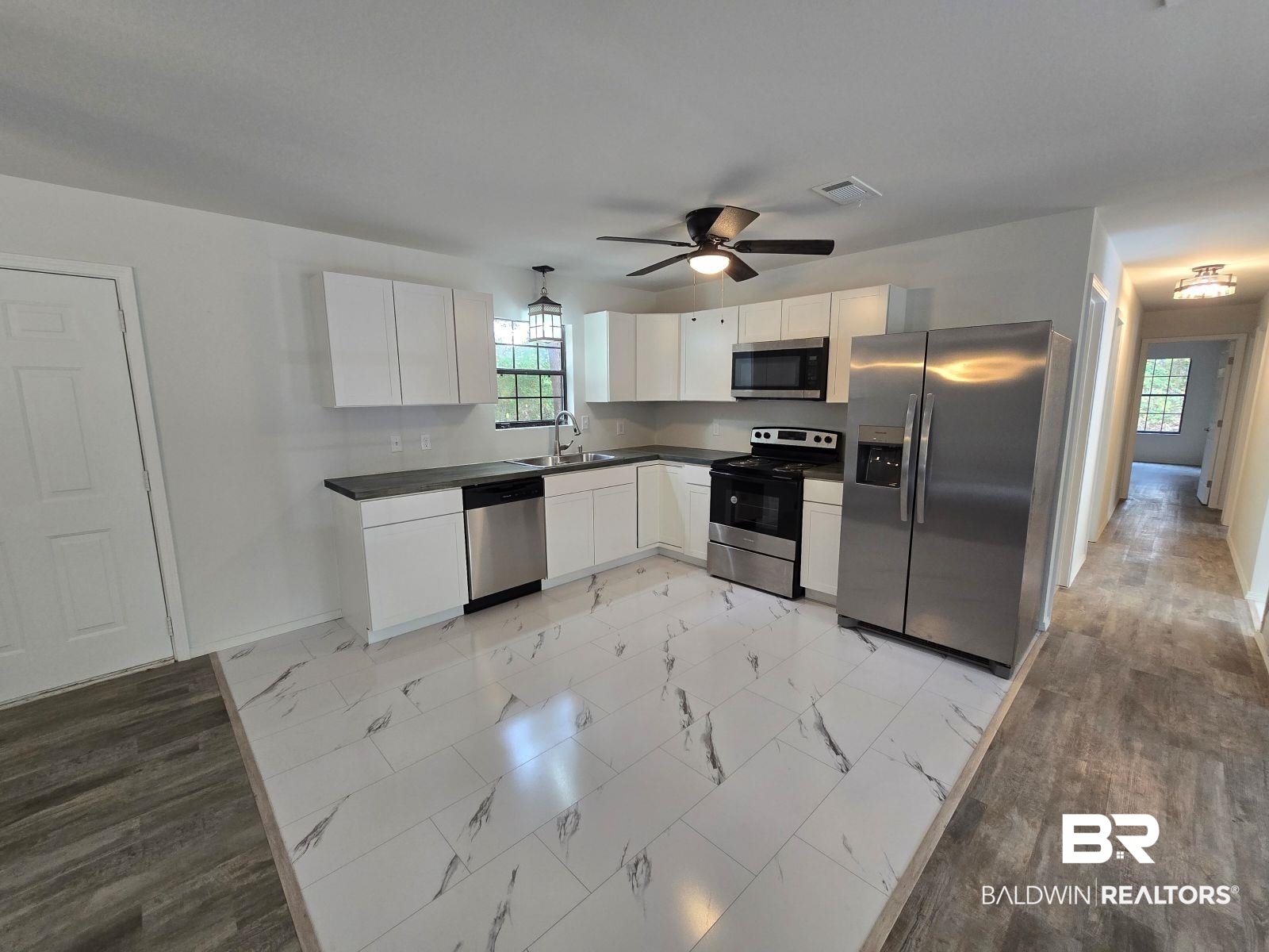 1600 Blair Road Brewton, AL 36426 - Photo 9 of 15 Kitchen featuring appliances with stainless steel finishes, white cabinets, sink, and ceiling fan