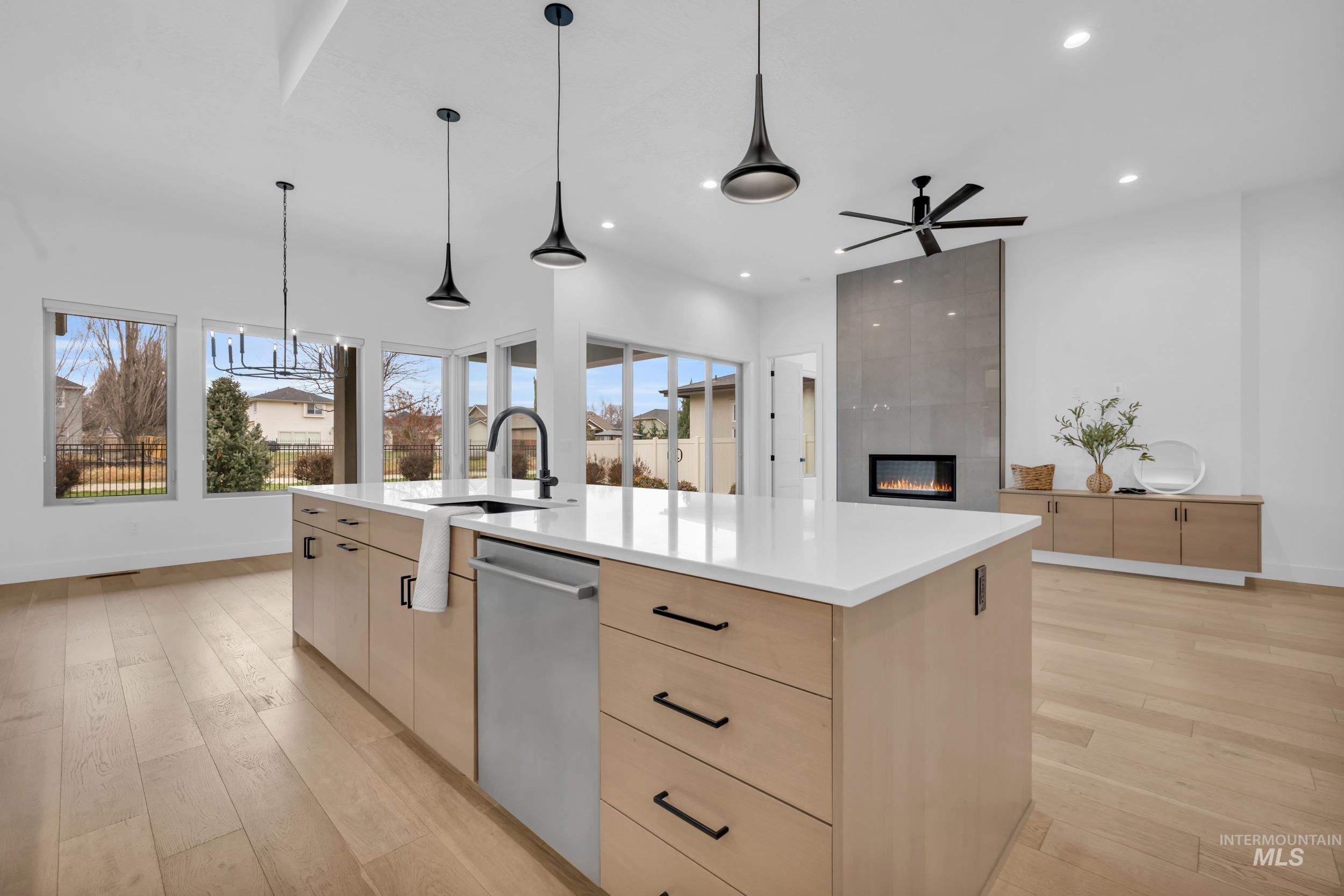4447 East Copper Point Drive Meridian, ID 83642 - Photo 10 of 42 Kitchen featuring light brown cabinetry, modern cabinets, light wood-style floors, pendant lighting, and recessed lighting
