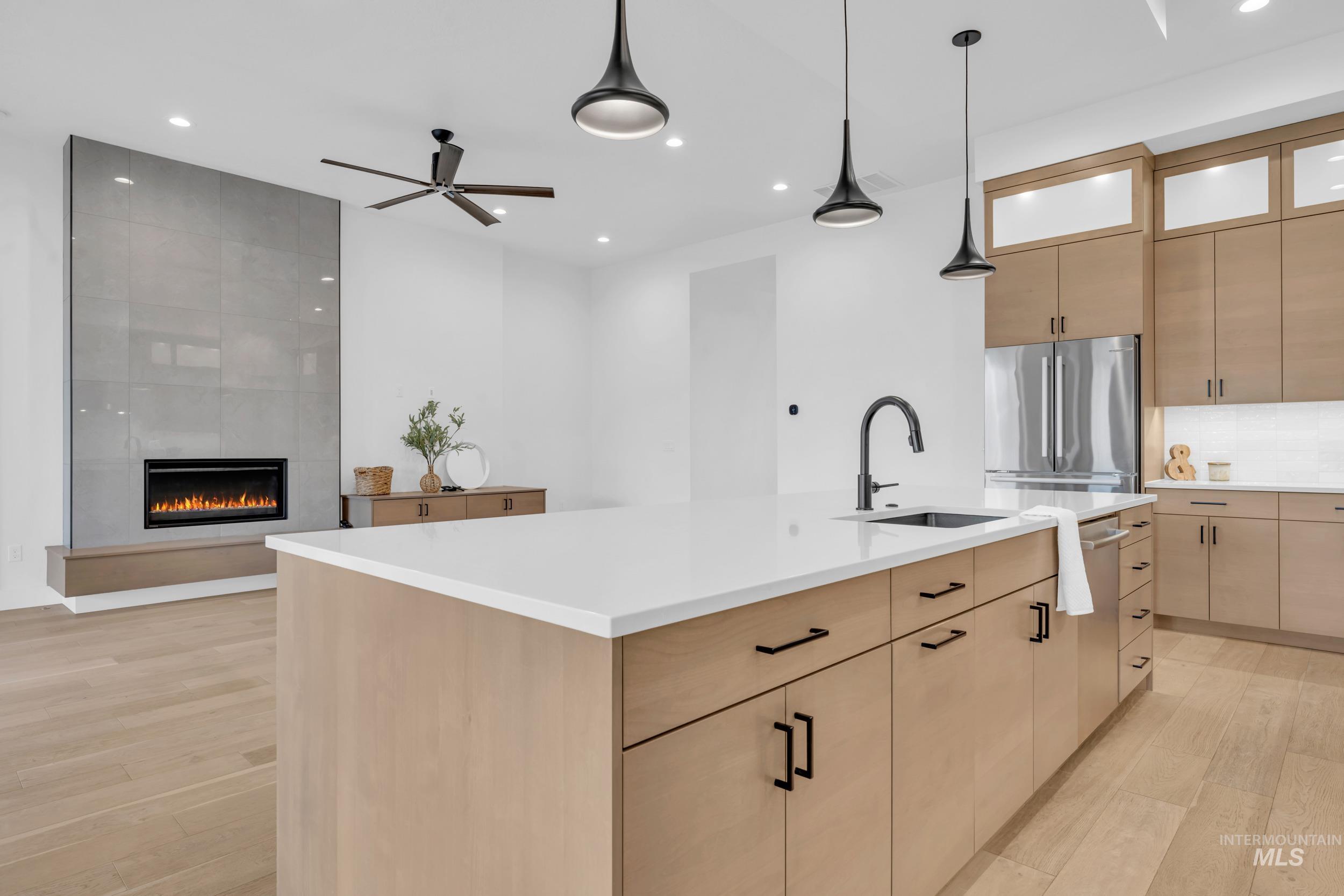 4447 East Copper Point Drive Meridian, ID 83642 - Photo 14 of 42 Kitchen featuring light brown cabinets, light wood finished floors, a spacious island, and recessed lighting