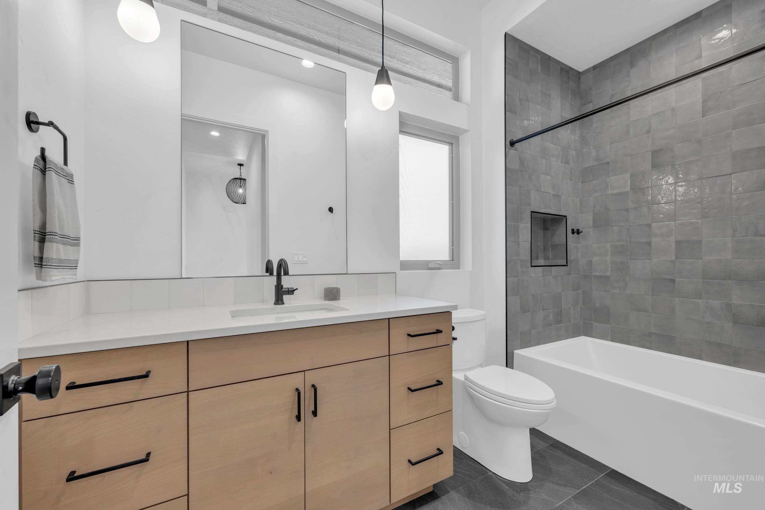 4447 East Copper Point Drive Meridian, ID 83642 - Photo 30 of 42 Full bathroom with vanity, shower / bathtub combination, and dark tile patterned flooring