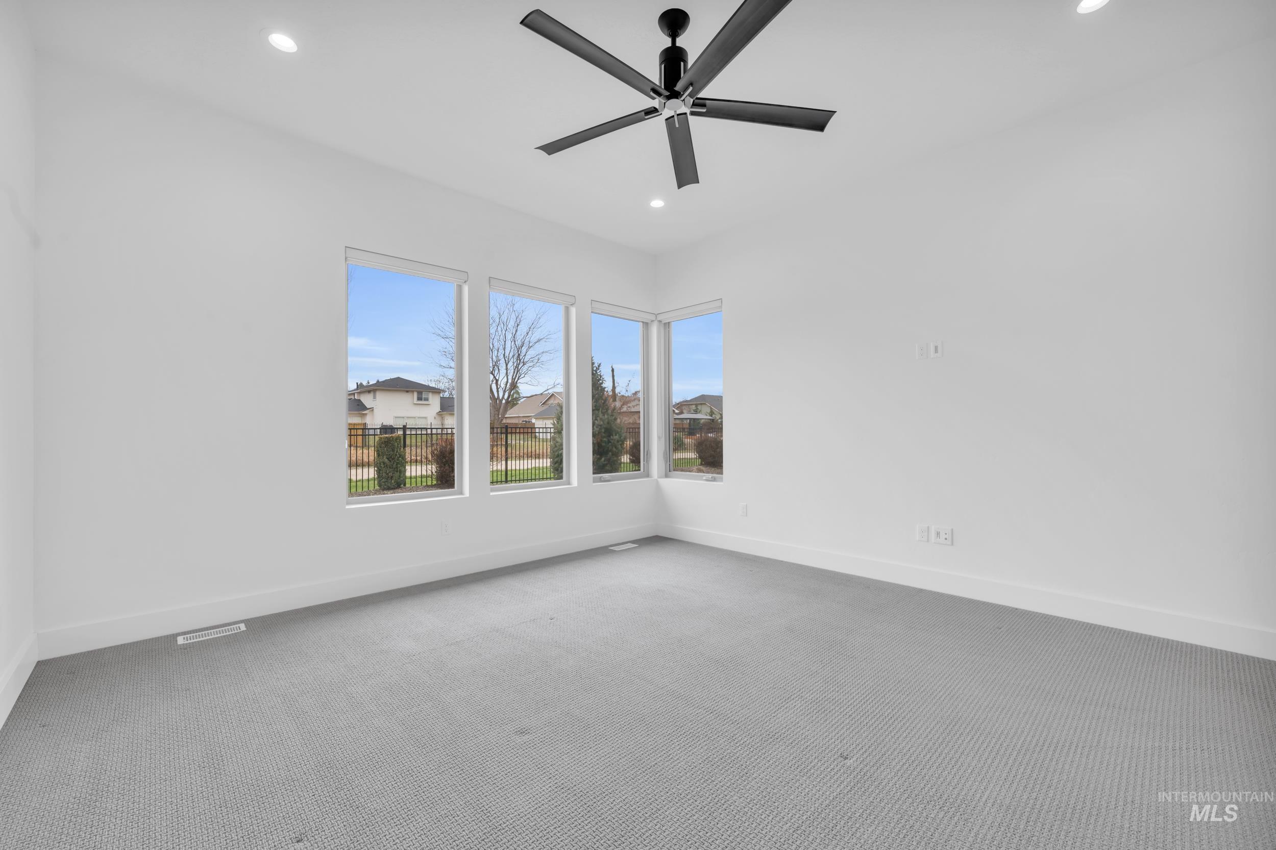 4447 East Copper Point Drive Meridian, ID 83642 - Photo 31 of 42 Carpeted spare room featuring recessed lighting and ceiling fan