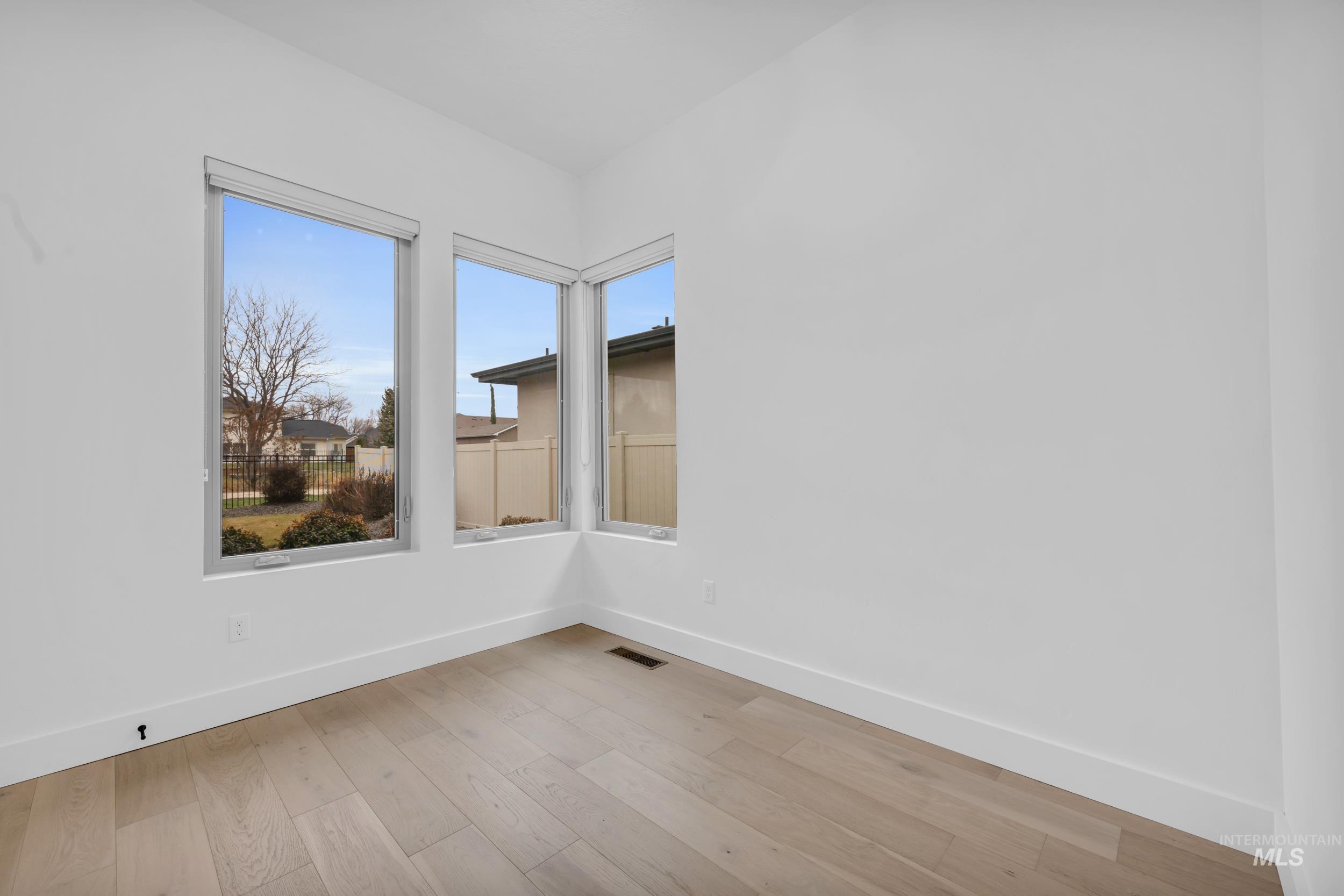 4447 East Copper Point Drive Meridian, ID 83642 - Photo 32 of 42 Spare room with baseboards and light wood finished floors