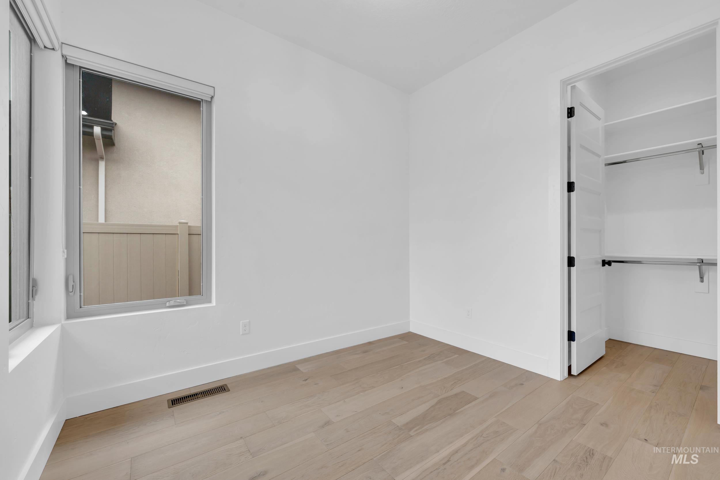 4447 East Copper Point Drive Meridian, ID 83642 - Photo 33 of 42 Unfurnished bedroom featuring light wood finished floors and a spacious closet