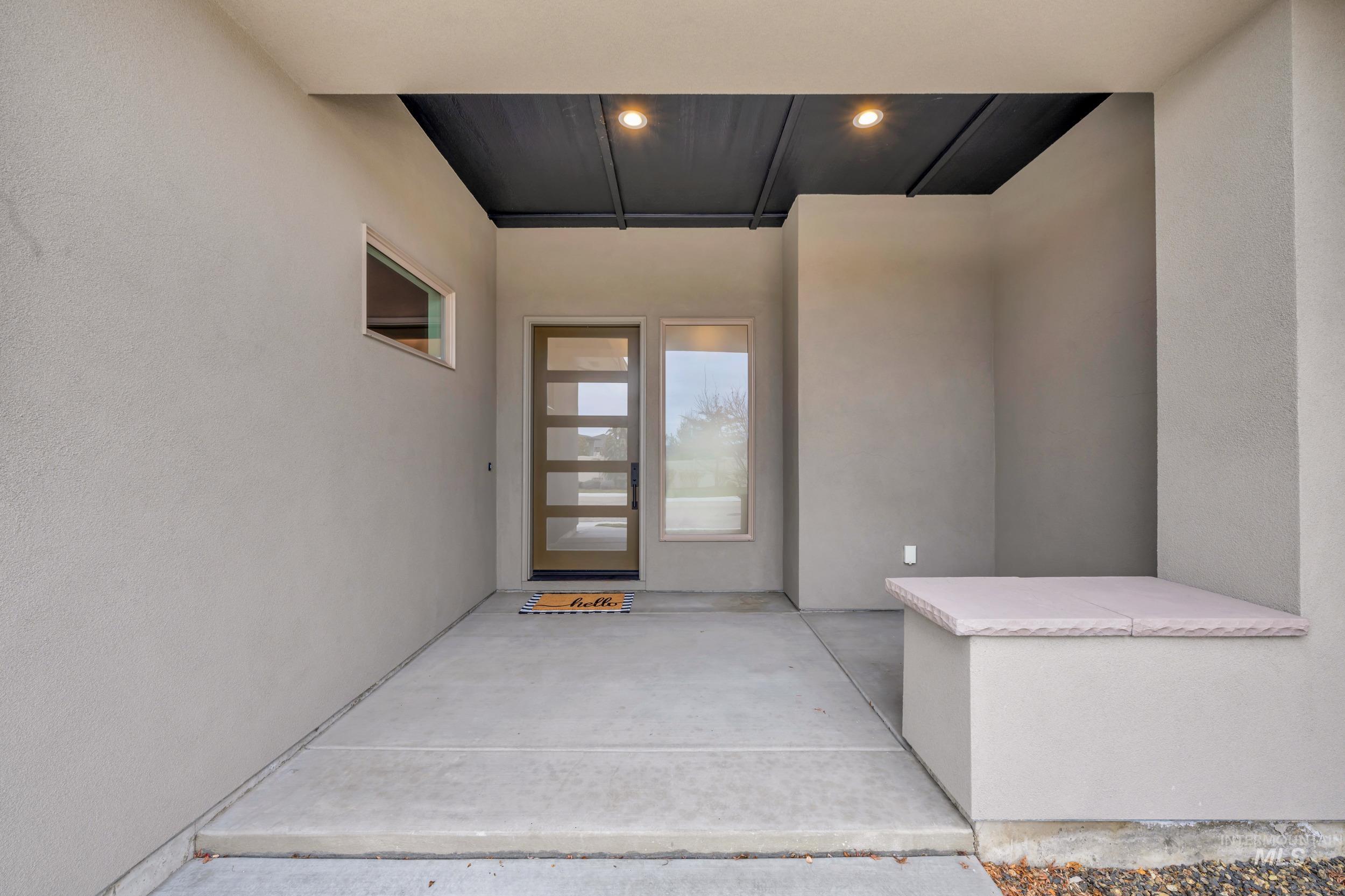 4447 East Copper Point Drive Meridian, ID 83642 - Photo 5 of 42 Property entrance with a patio and stucco siding