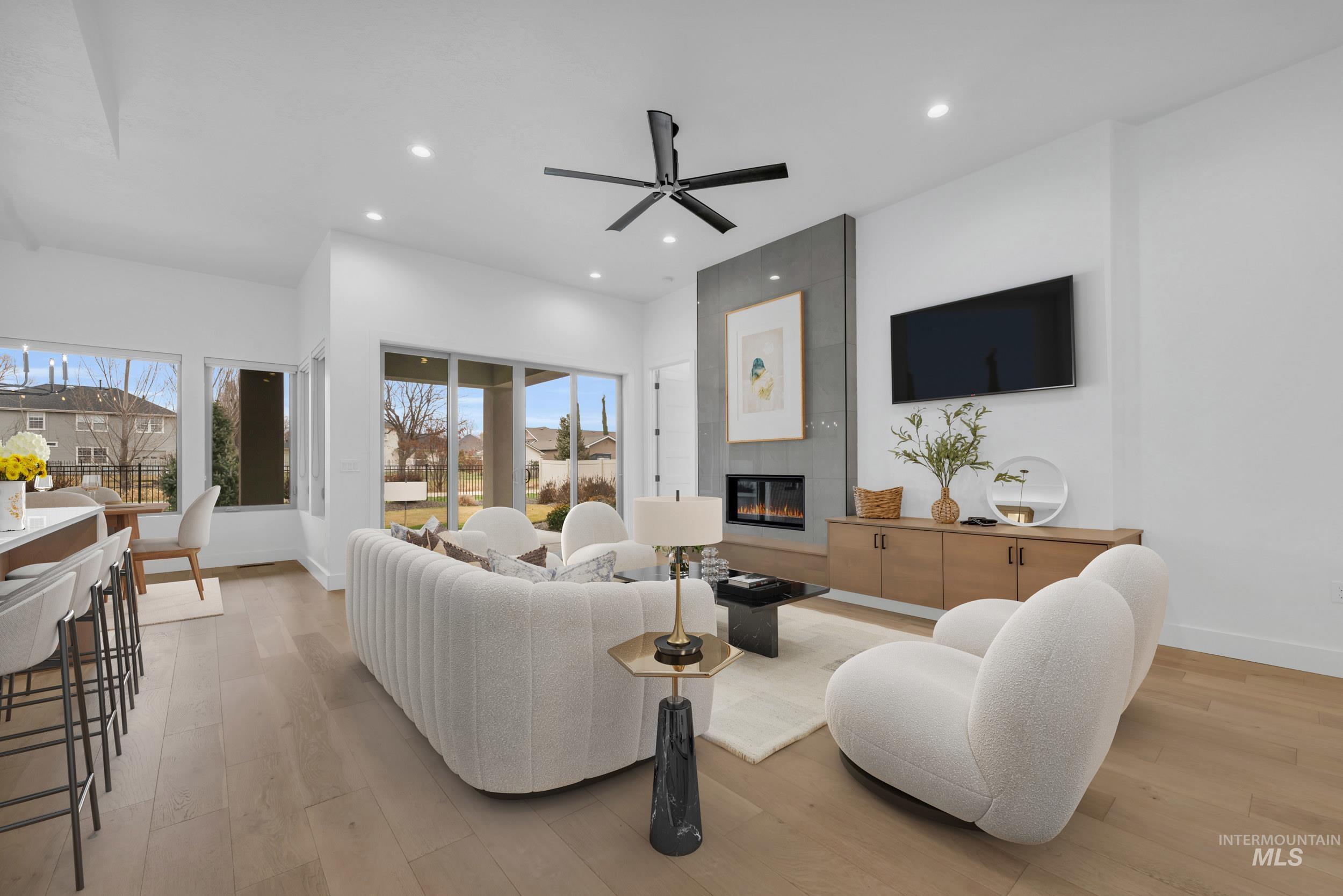 4447 East Copper Point Drive Meridian, ID 83642 - Photo 7 of 42 Living room featuring light wood-type flooring, a fireplace, ceiling fan, and recessed lighting