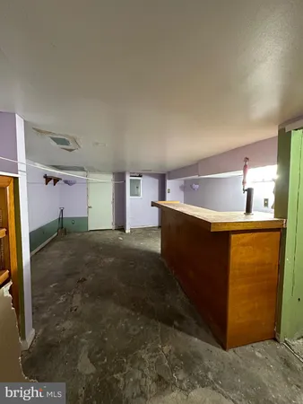 a kitchen with kitchen island sink and refrigerator