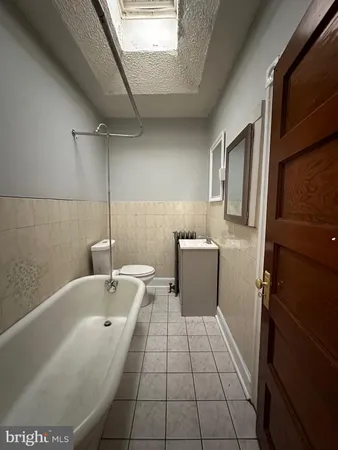 a bathroom with a sink a toilet and bathtub