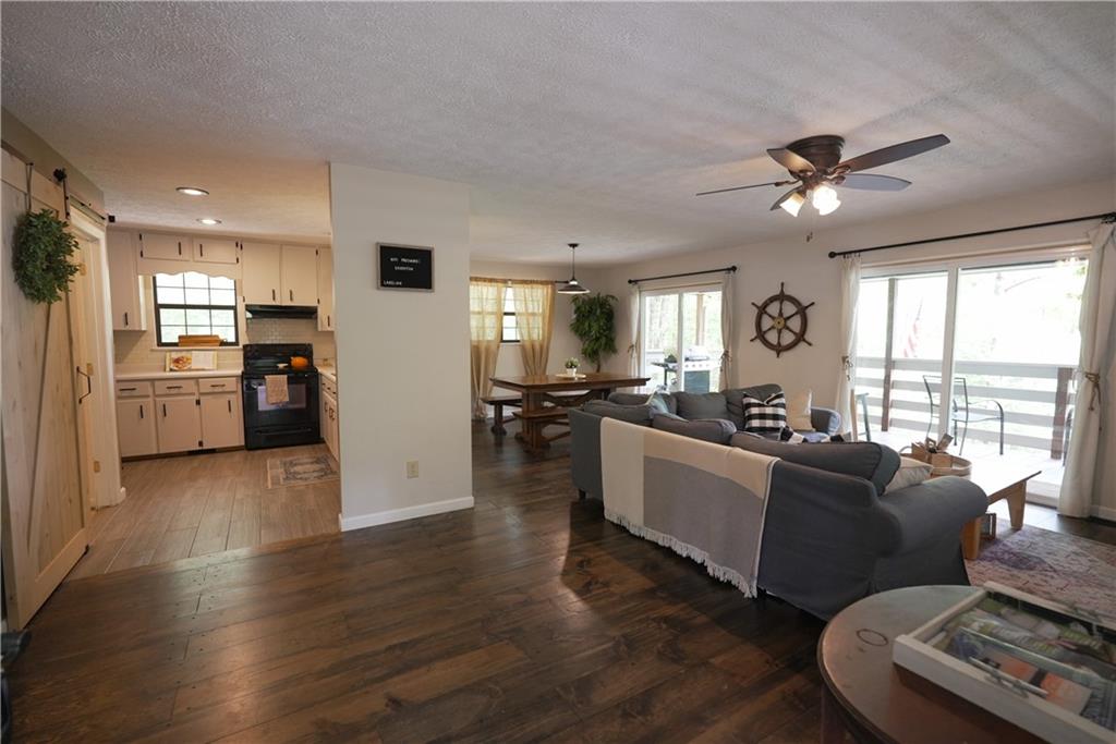 a living room with furniture and kitchen view