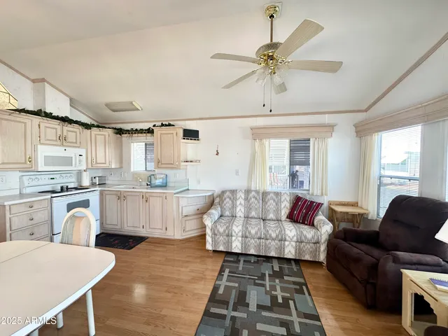 a living room with furniture and kitchen view