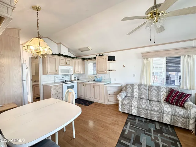 a living room with kitchen island furniture and a chandelier