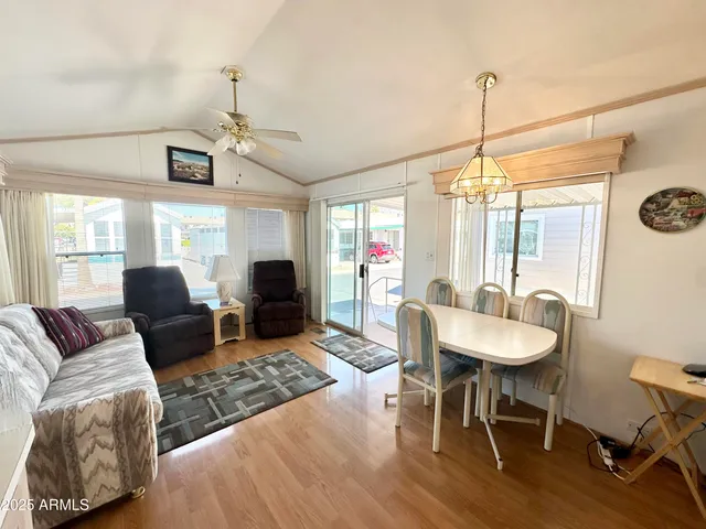 a living room with furniture a ceiling fan and a window