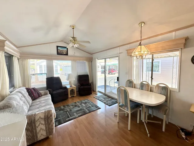 a living room with furniture a window and a chandelier