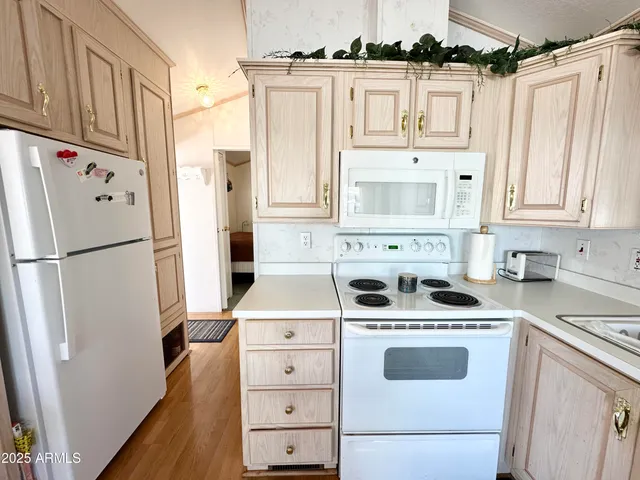 a kitchen with a sink stove top oven and cabinets