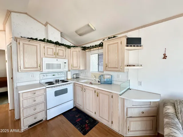 a kitchen with white cabinets and white appliances