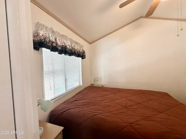 a bedroom with a bed and a window