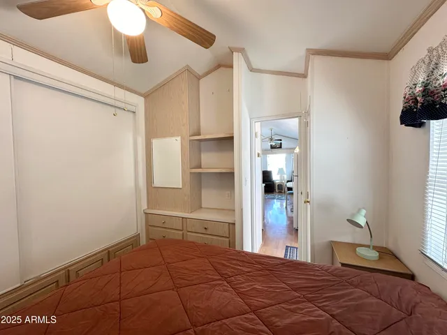 a bedroom with a bed and a window