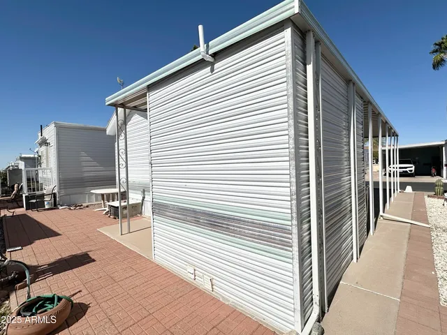 a view of a patio with dining table and chairs with wooden floor and fence