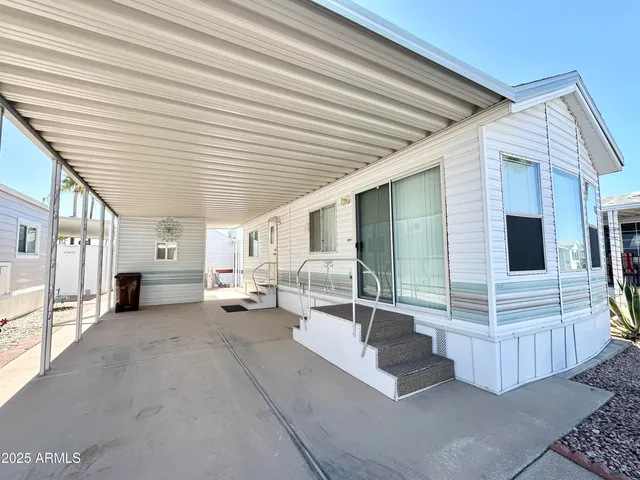 a view of a patio with couches next to a yard