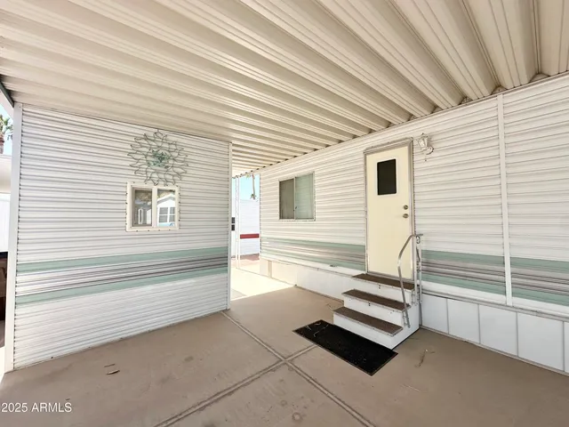 a view of a two chairs in the balcony