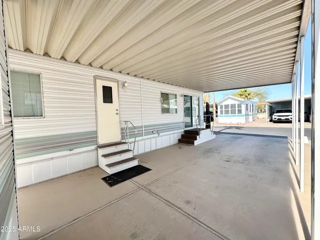 a view of a porch with a table and chairs