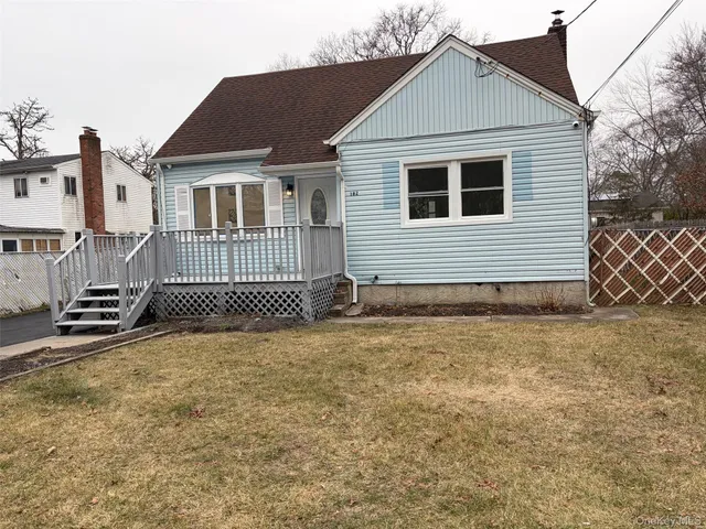 a view of a house with a backyard