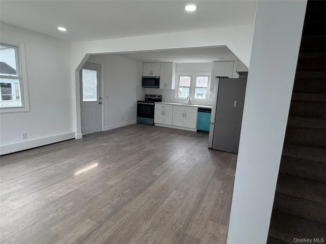a bathroom with a granite countertop sink a toilet and a mirror