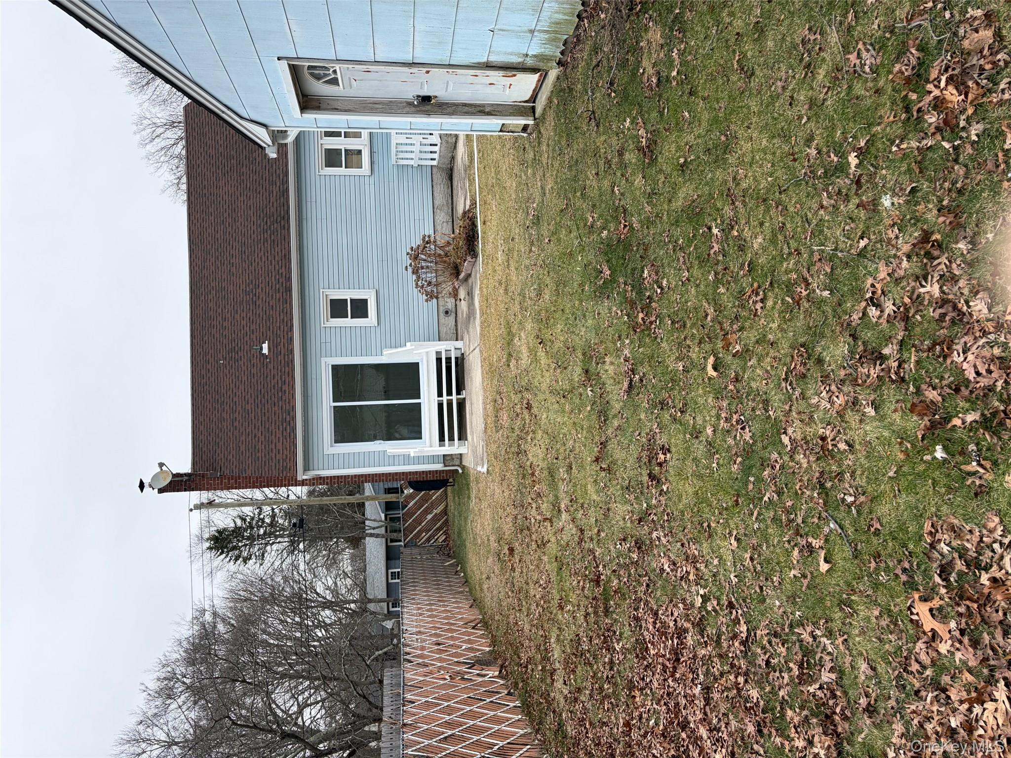 182 Lexington Road Shirley, NY 11967 - Photo 7 of 16 a front view of a house with garden