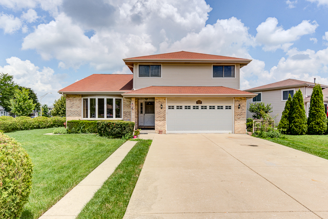 2174 Cimarron Way Addison, IL 60101 - Photo 1 of 19 a front view of a house with yard