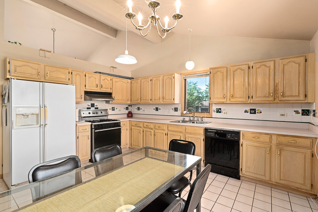 2174 Cimarron Way Addison, IL 60101 - Photo 11 of 19 a kitchen with kitchen island granite countertop a sink appliances cabinets and a counter top
