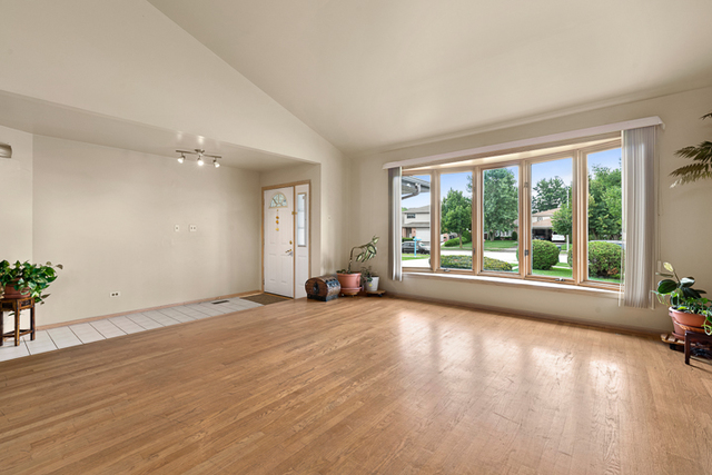 2174 Cimarron Way Addison, IL 60101 - Photo 3 of 19 a view of an empty room with a window and wooden floor