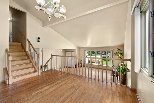 2174 Cimarron Way Addison, IL 60101 - Photo 6 of 19 a view of a room with wooden floor staircase and windows