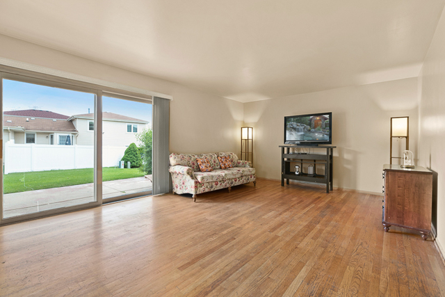 2174 Cimarron Way Addison, IL 60101 - Photo 7 of 19 a view of livingroom with furniture and floor to ceiling window