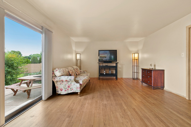 2174 Cimarron Way Addison, IL 60101 - Photo 8 of 19 a living room with furniture and a flat screen tv