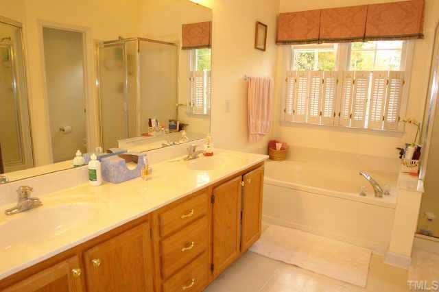 5300 Blakeley Lane Raleigh, NC 27613 - Photo 9 of 12 a bathroom with a tub sink and mirror