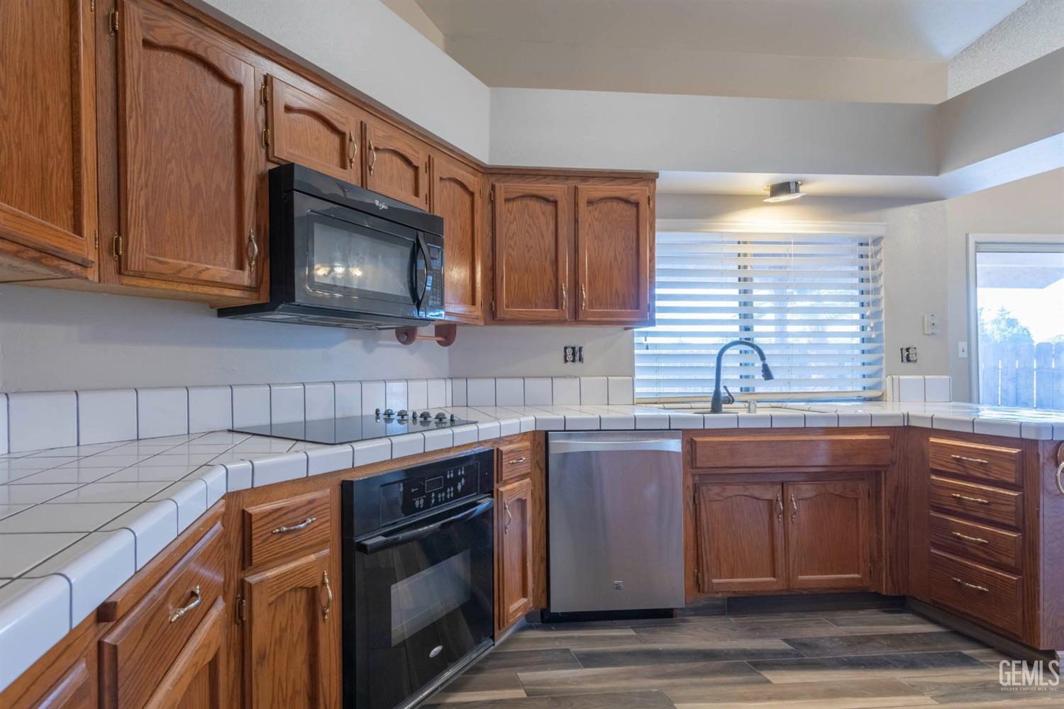 Undisclosed Address Bakersfield, CA 93314 - Photo 11 of 31 a kitchen with stainless steel appliances granite countertop a sink stove and microwave