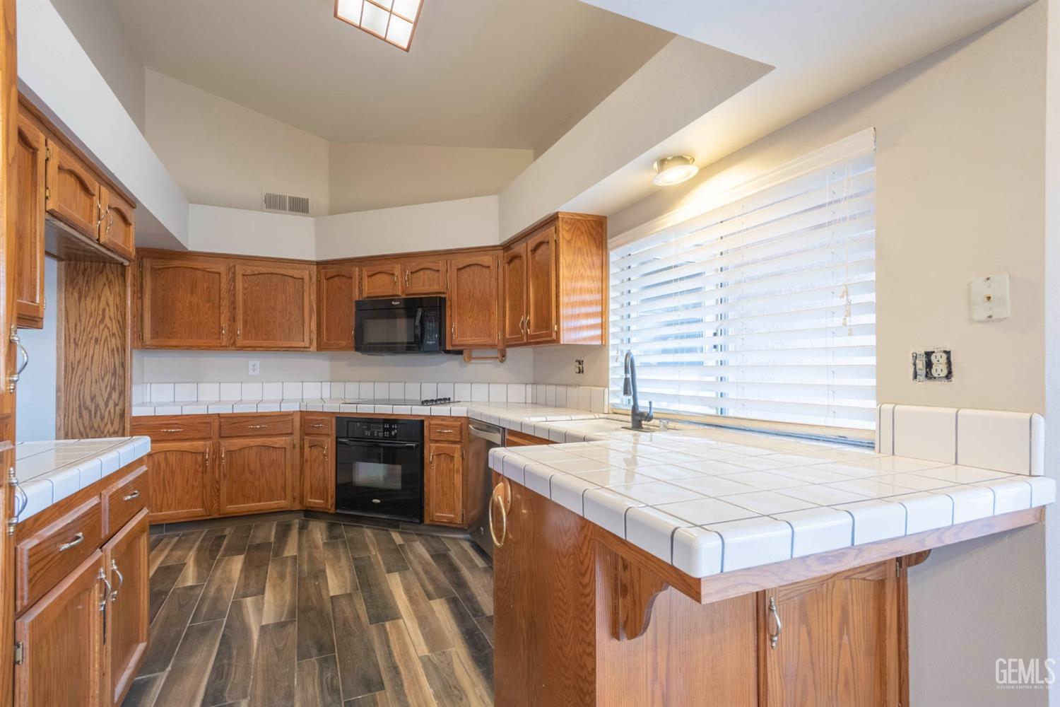 Undisclosed Address Bakersfield, CA 93314 - Photo 12 of 31 a kitchen with granite countertop a sink stove and cabinets