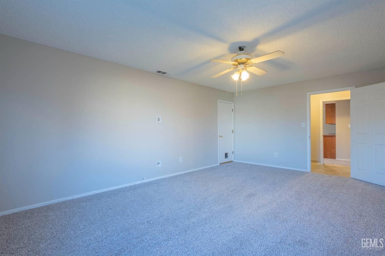 Undisclosed Address Bakersfield, CA 93314 - Photo 14 of 31 a view of a room with a ceiling fan and a chandelier fan