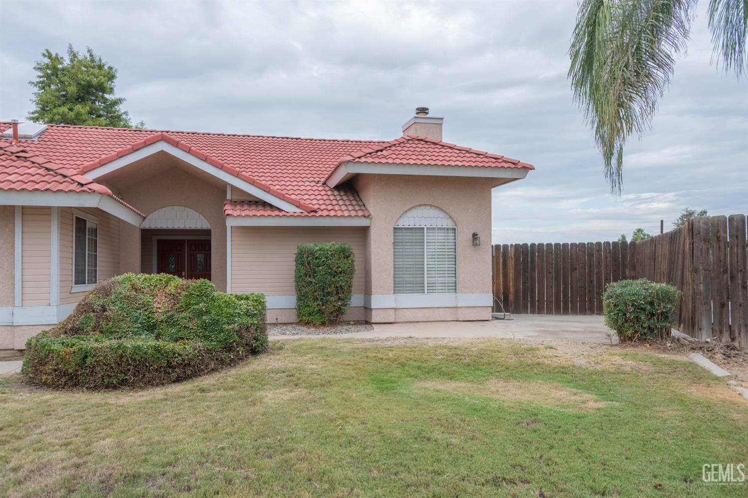 Undisclosed Address Bakersfield, CA 93314 - Photo 2 of 31 a front view of a house with garden