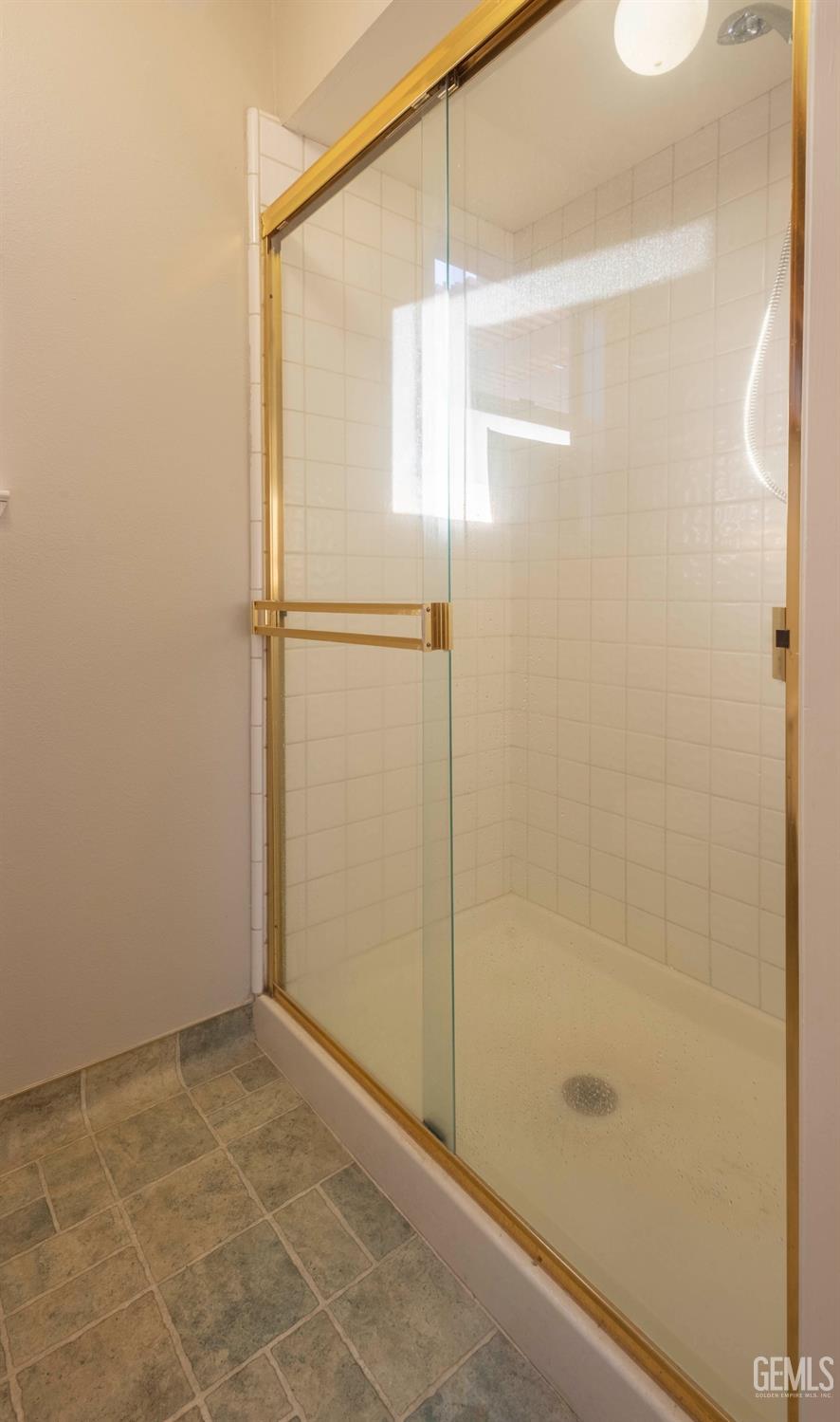 Undisclosed Address Bakersfield, CA 93314 - Photo 24 of 31 a bathroom with a glass shower door