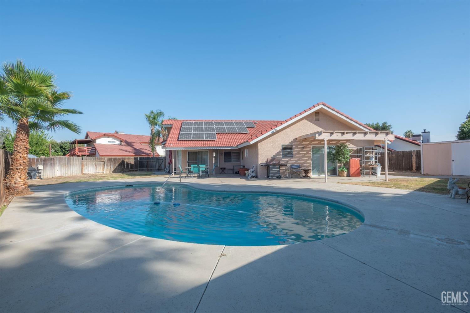 Undisclosed Address Bakersfield, CA 93314 - Photo 4 of 31 a view of a house with swimming pool