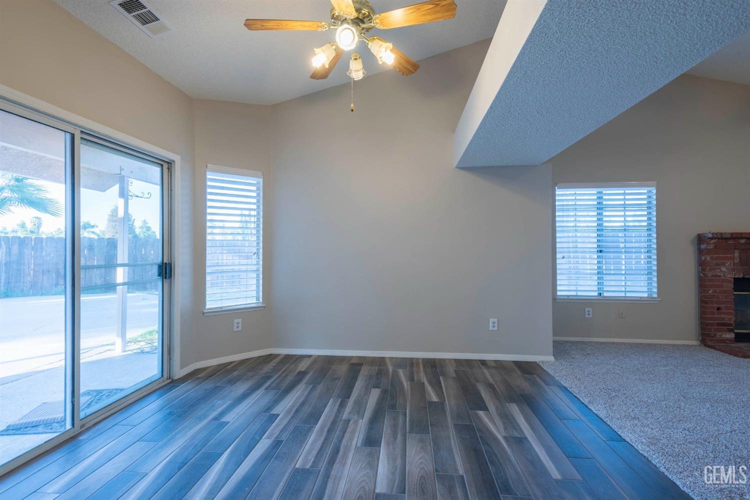 Undisclosed Address Bakersfield, CA 93314 - Photo 10 of 31 an empty room with wooden floor and windows