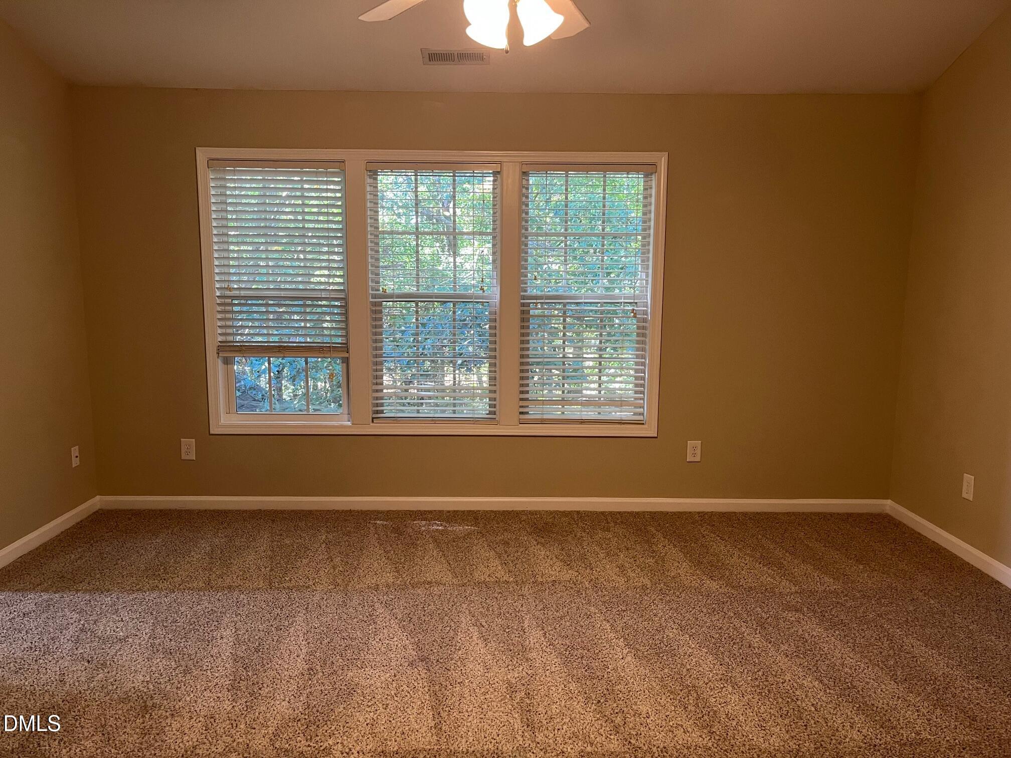 8165 Rolling Glenn Drive Raleigh, NC 27616 - Photo 11 of 14 an empty room with a window
