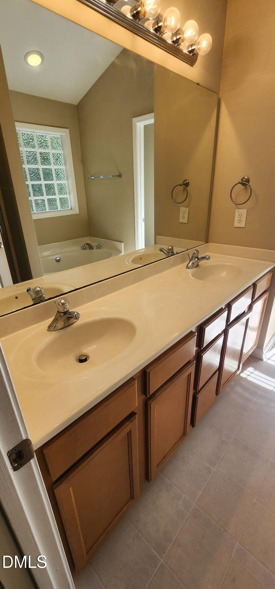 8165 Rolling Glenn Drive Raleigh, NC 27616 - Photo 13 of 14 a bathroom with a sink and a mirror
