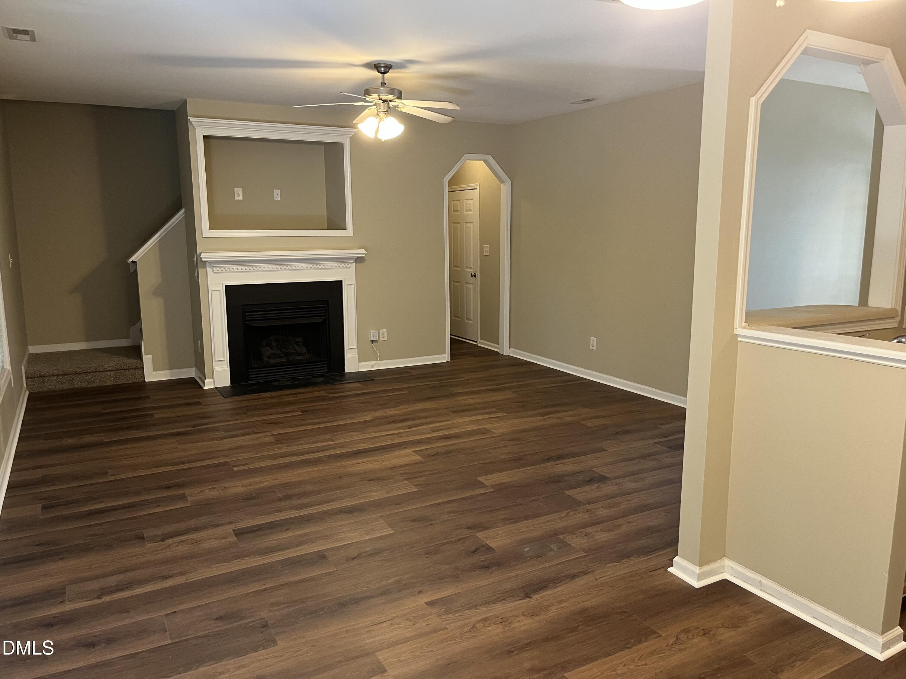 8165 Rolling Glenn Drive Raleigh, NC 27616 - Photo 3 of 14 a view of a livingroom with wooden floor and a fireplace