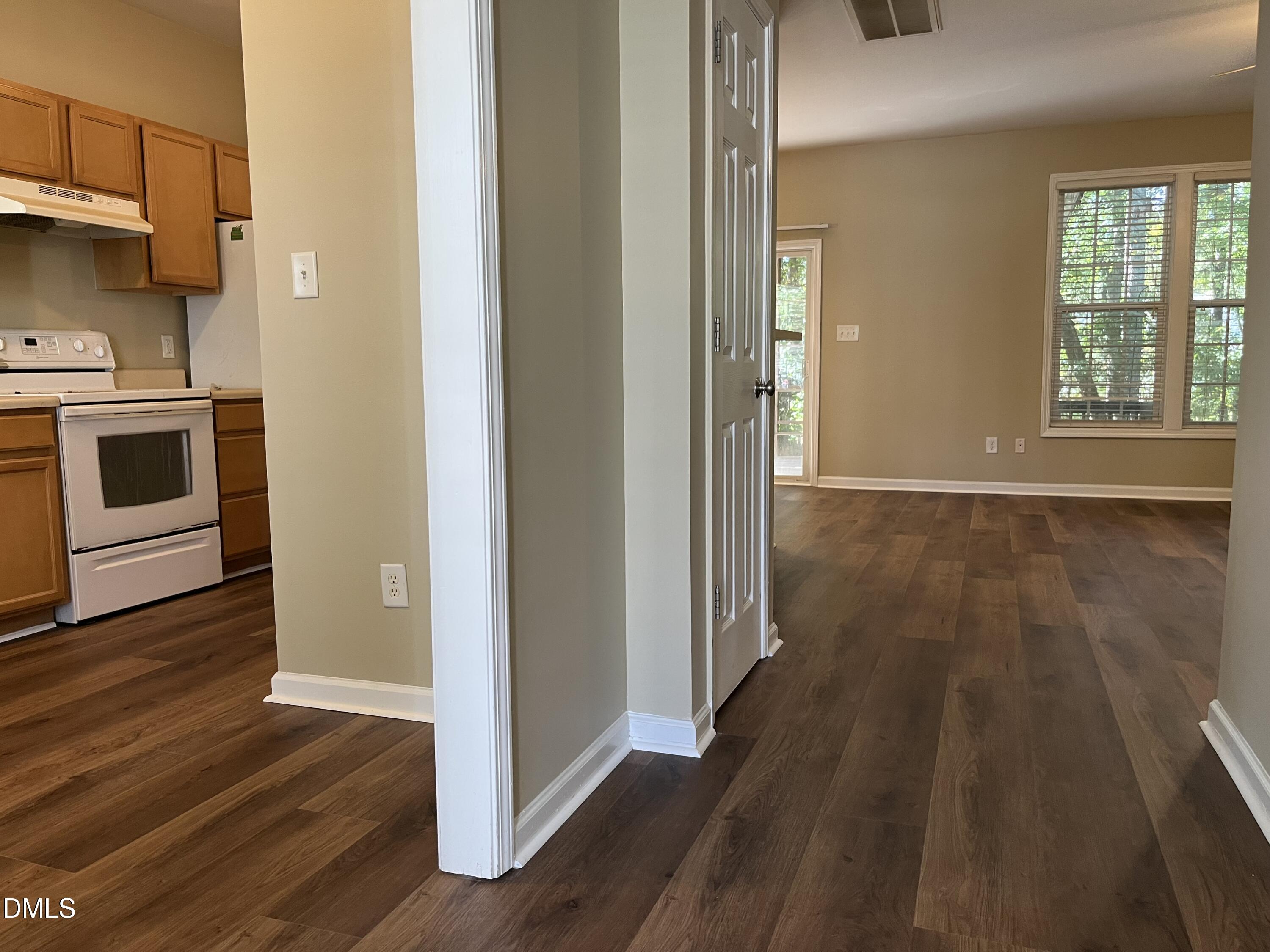 8165 Rolling Glenn Drive Raleigh, NC 27616 - Photo 4 of 14 a view of a hallway with wooden floor and cabinets